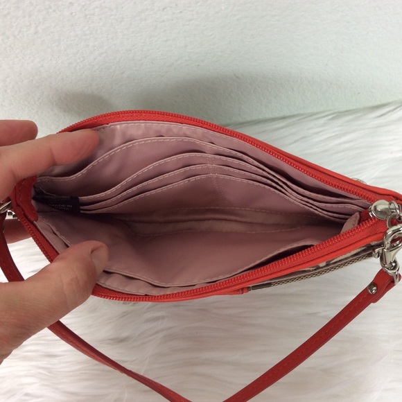 Coach logo wristlet accented with a deep orange. - Picture 3 of 7